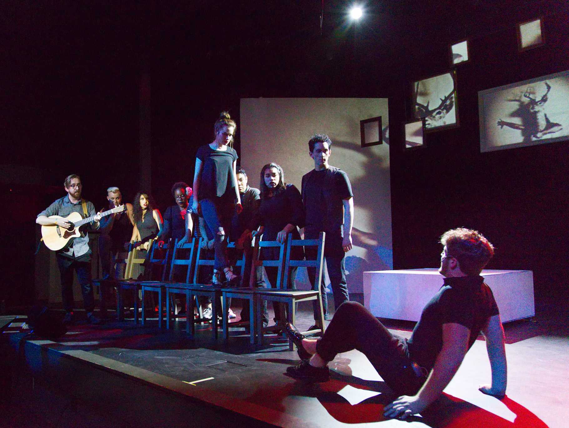 Scene with man on the floor backing up as his wife towers over him in 35 MM: A Musical Exhibition.